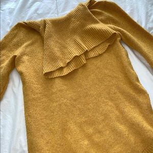 Mustard yellow turtleneck sweater.